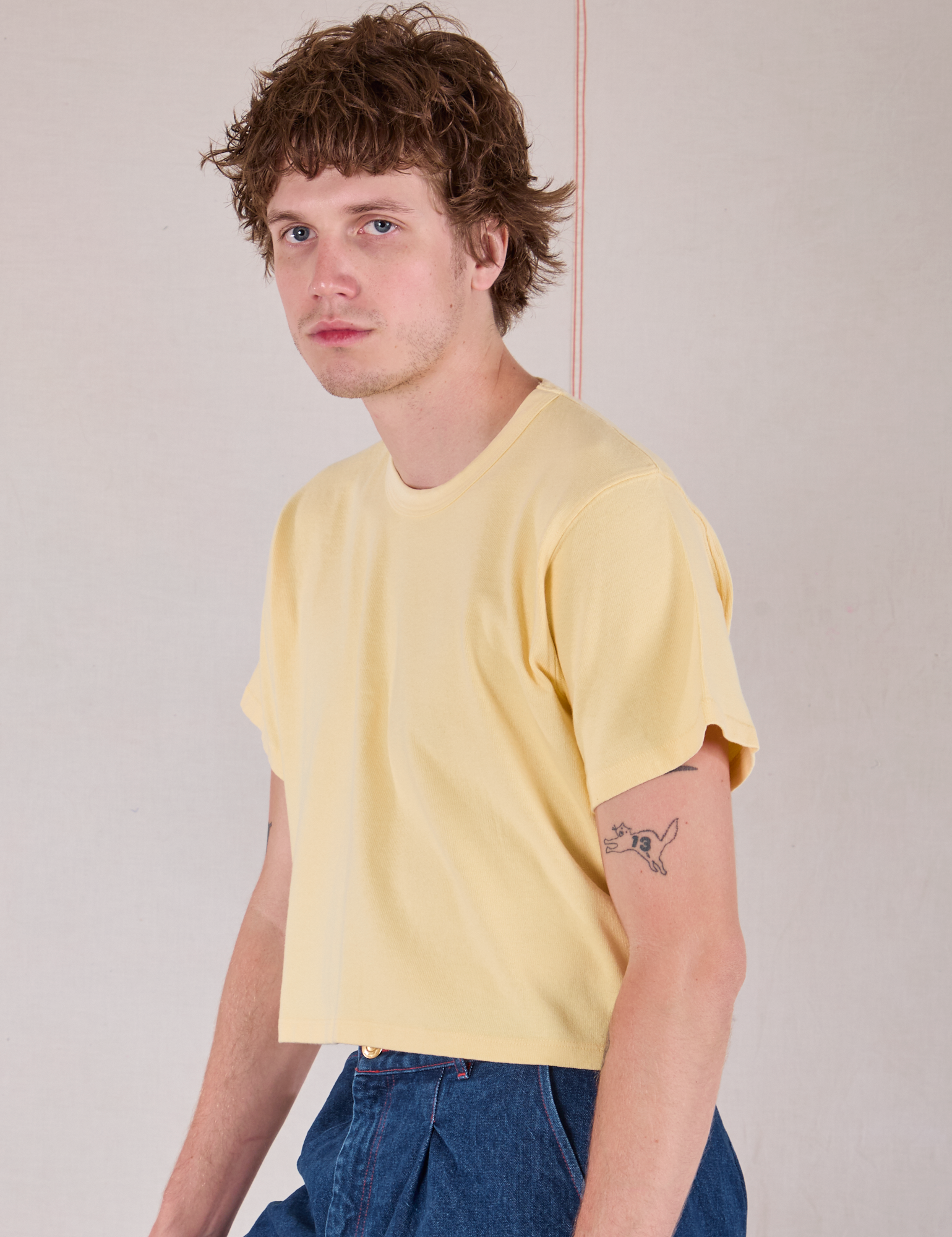 Cropped Burly Tee in Butter Yellow side view on Quinn
