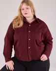 Juliet is wearing a buttoned up Cropped Overshirt in Red Wine