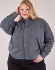 Juliet is wearing a buttoned up Cropped Overshirt in Slate Grey