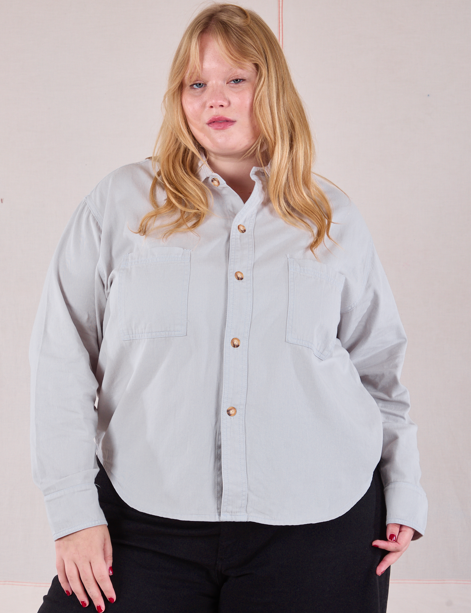 Juliet is wearing a buttoned up Cropped Overshirt in Stone White