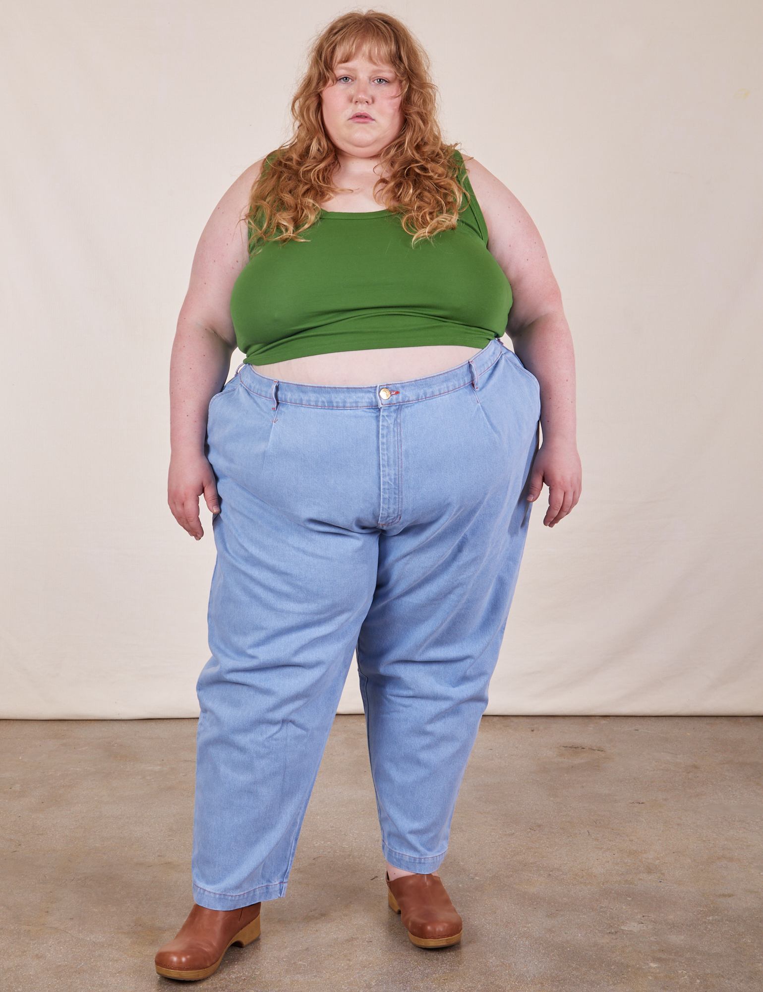 Catie is wearing Cropped Tank Top in Lawn Green and light wash Trouser Jeans