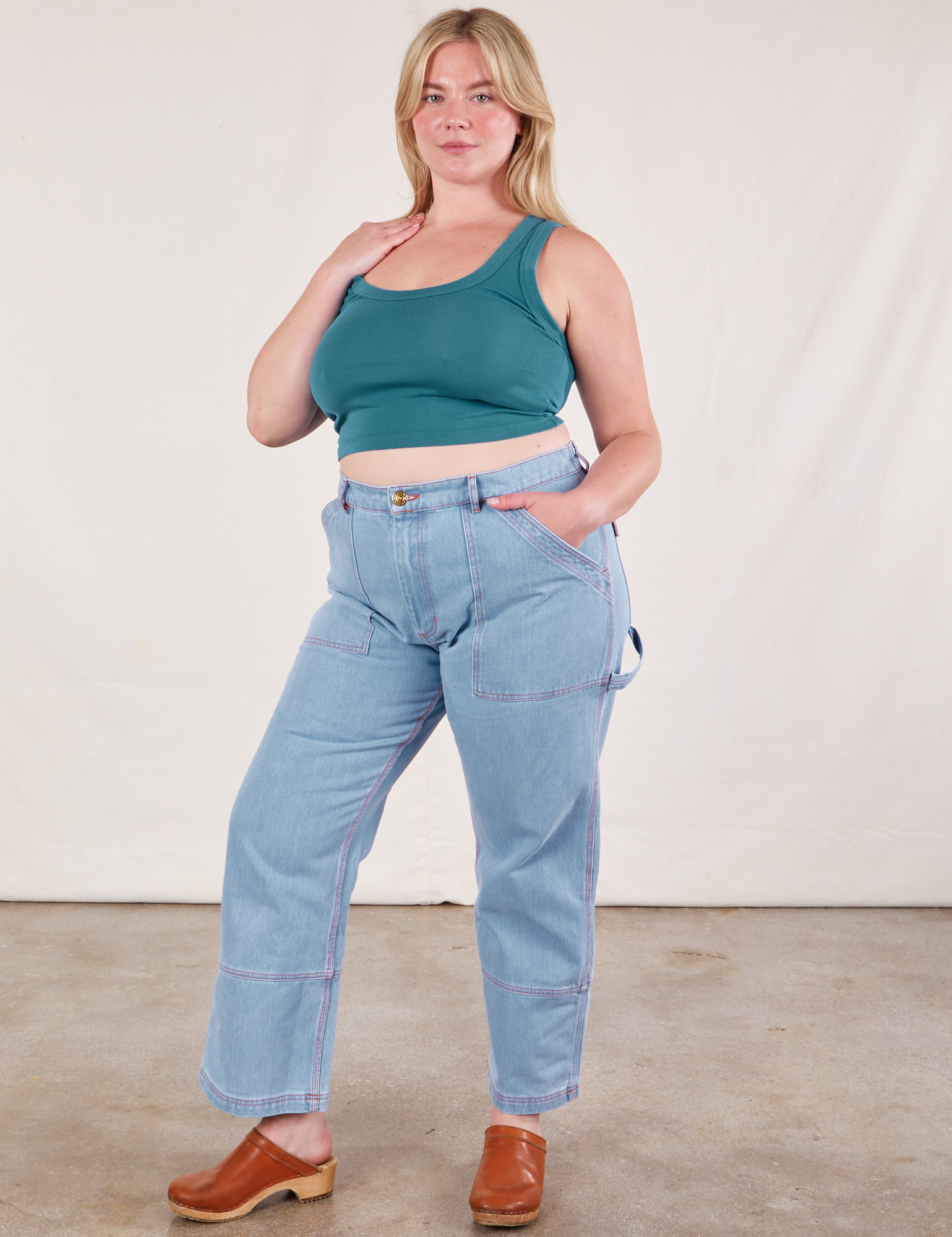 Lish is wearing Cropped Tank Top in Marine Blue and light wash Carpenter Jeans