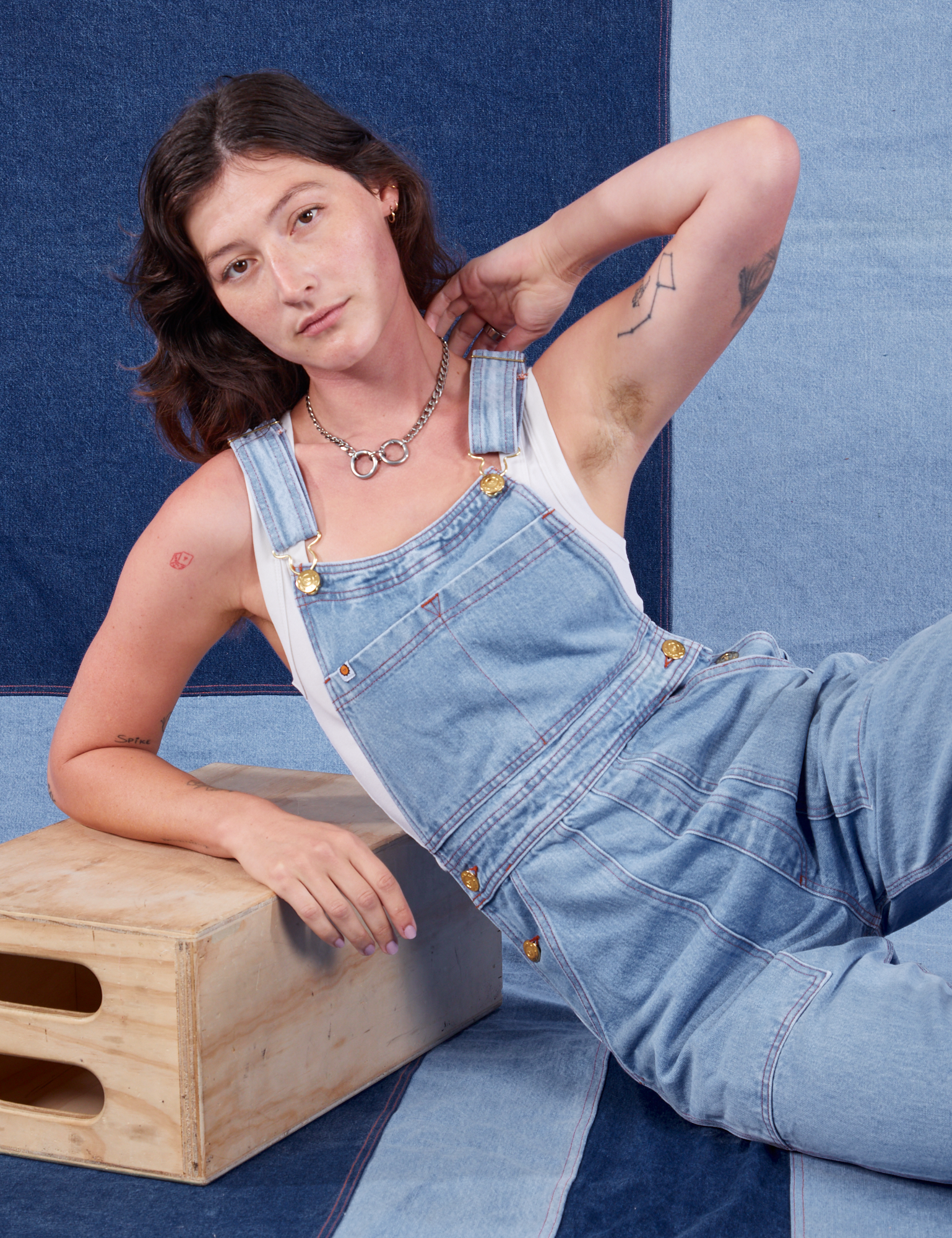 Alex is wearing Indigo Denim Original Overalls in Light Wash