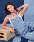 Alex is wearing Indigo Denim Original Overalls in Light Wash