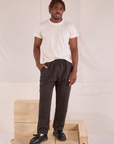 Issac is wearing Easy Pants in Espresso Brown and Organic Vintage Tee in vintage tee off-white