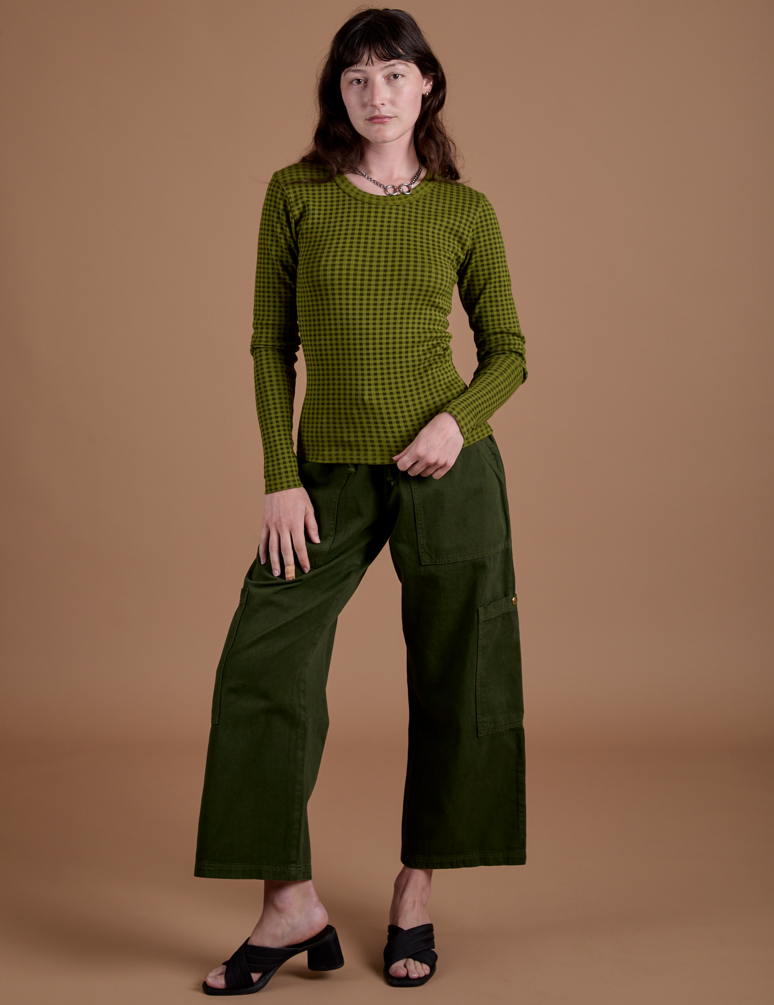 Alex is wearing Gingham Long Sleeve Baby Tee in Summer Olive and evergreen Drop Pocket Cargo Pants