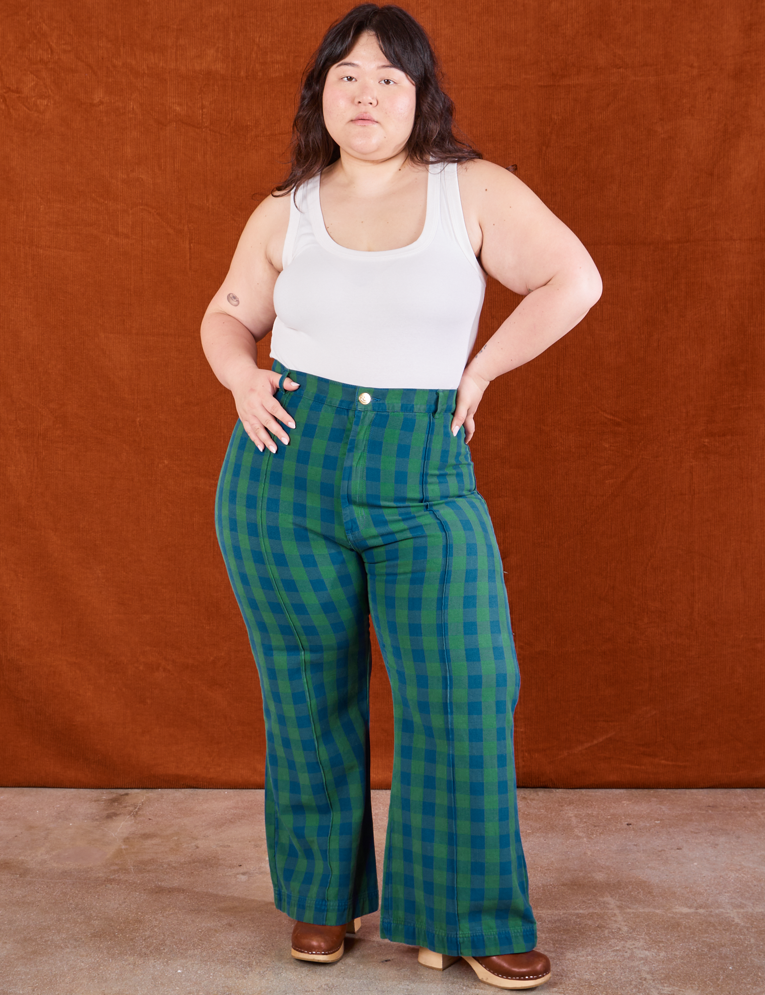 Ashley is 5&#39;7&quot; and wearing 0XL Gingham Western Pants in Green paired with a Cropped Tank in vintage tee off-white