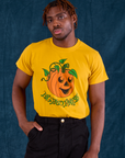 Issac is wearing Halloween Organic Tee in Pumpkin tucked into black Work Pants