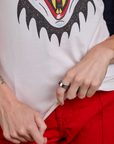 Alex is holding the bottom hem of Raglan Tee in Dracula