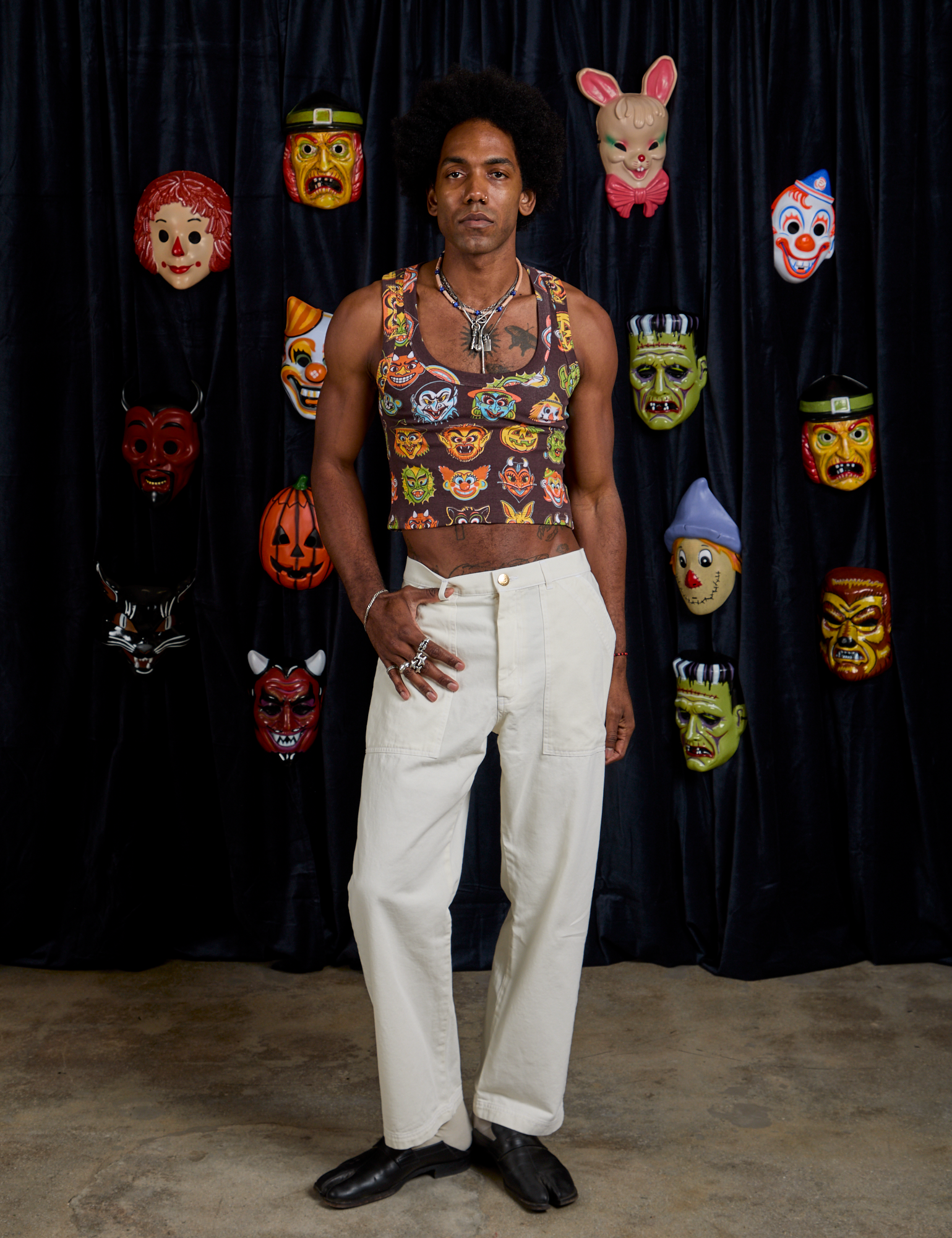 Jerrod is wearing Cropped Tank Top in Halloween Masks and vintage tee white Work Pants