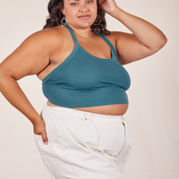 Angled view of Halter Top in Marine Blue and vintage off-white Western Pants worn by Alicia