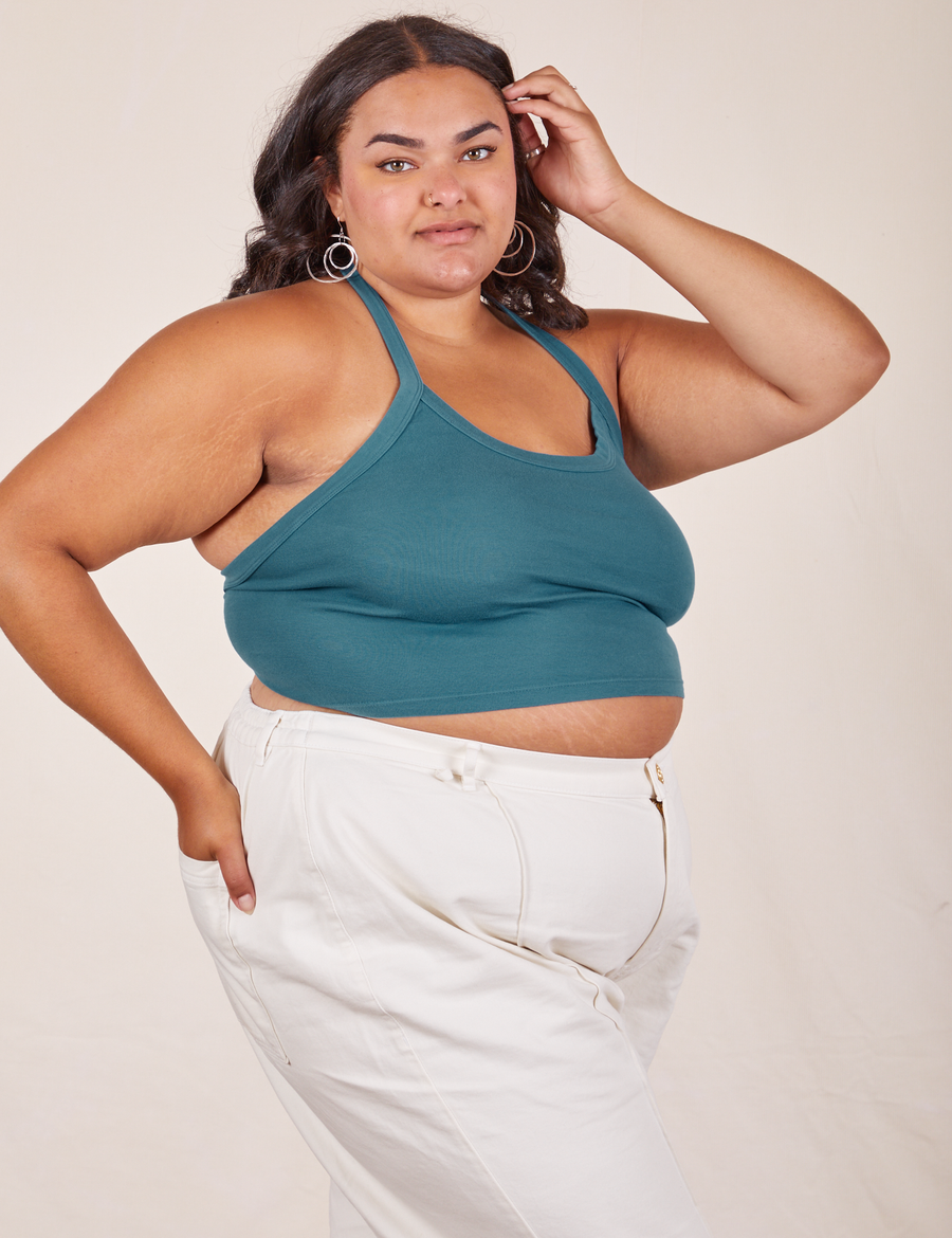 Angled view of Halter Top in Marine Blue and vintage off-white Western Pants worn by Alicia