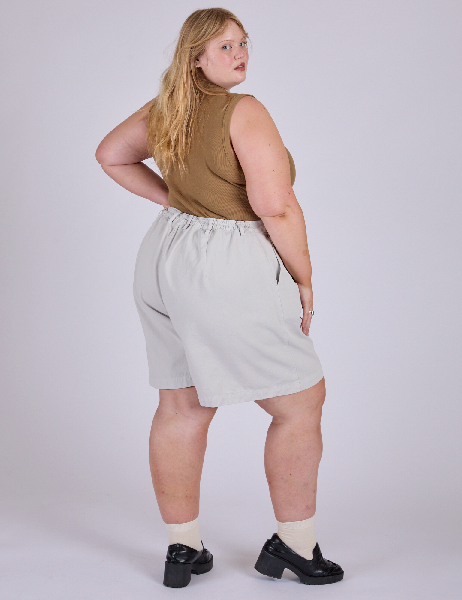 Pleated Trouser Shorts in Dishwater White angled back view on Juliet