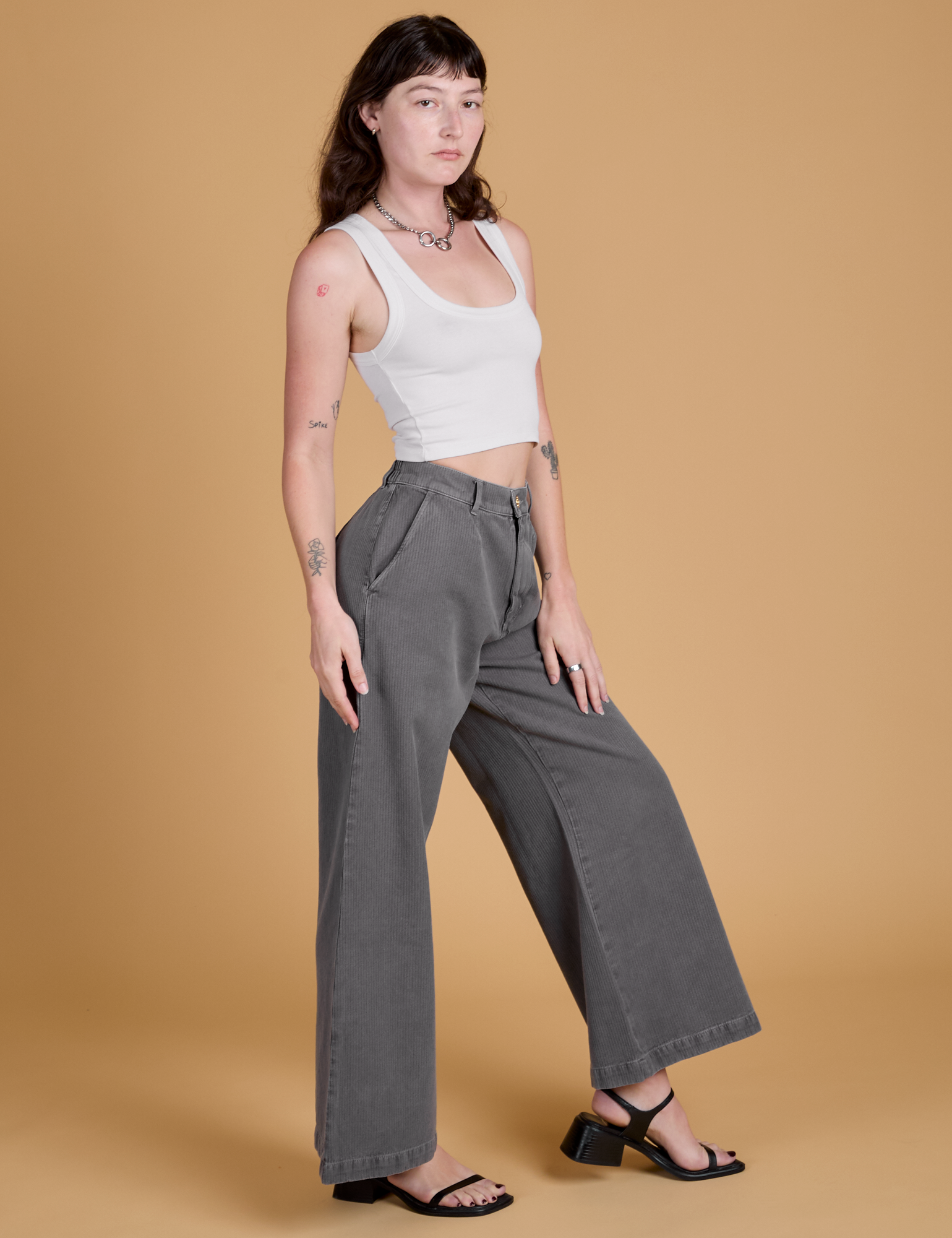 Side view of Heritage Wide Leg Trousers in Washed Grey and Cropped Tank in Vintage Tee White on Alex
