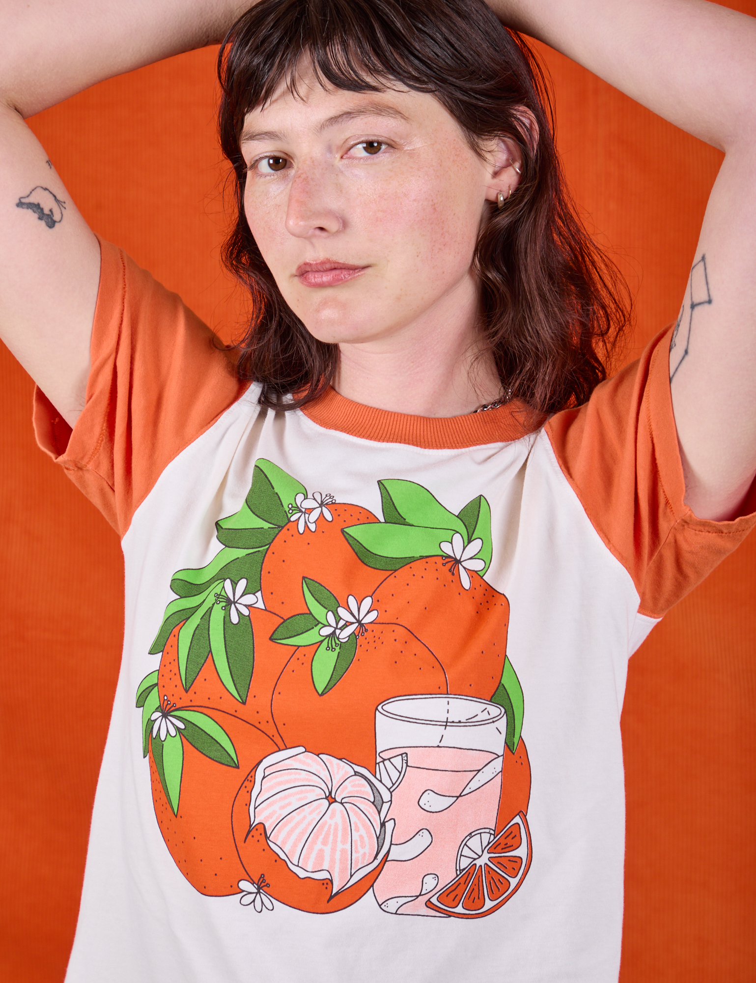 Anniversary Tee in Orange Blossom front close up on Alex