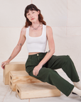 Alex is wearing Heritage Trousers in Swamp Green and vintage off-white Cropped Tank Top