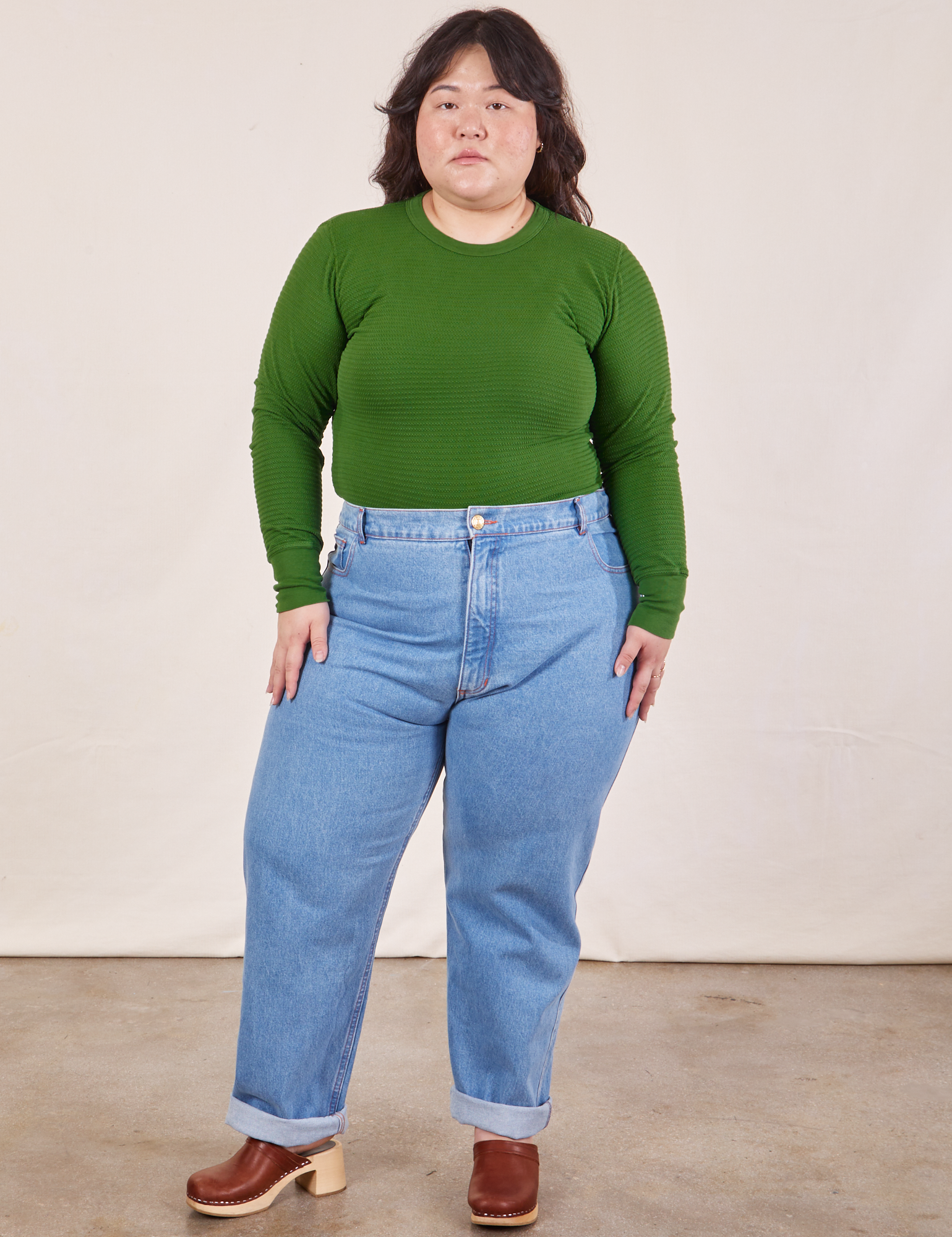 Ashley is wearing Honeycomb Thermal in Lawn Green tucked into light wash Frontier Jeans