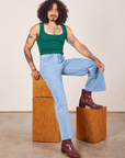 Jesse is wearing Cropped Tank Top in Hunter Green and light wash Sailor Jeans
