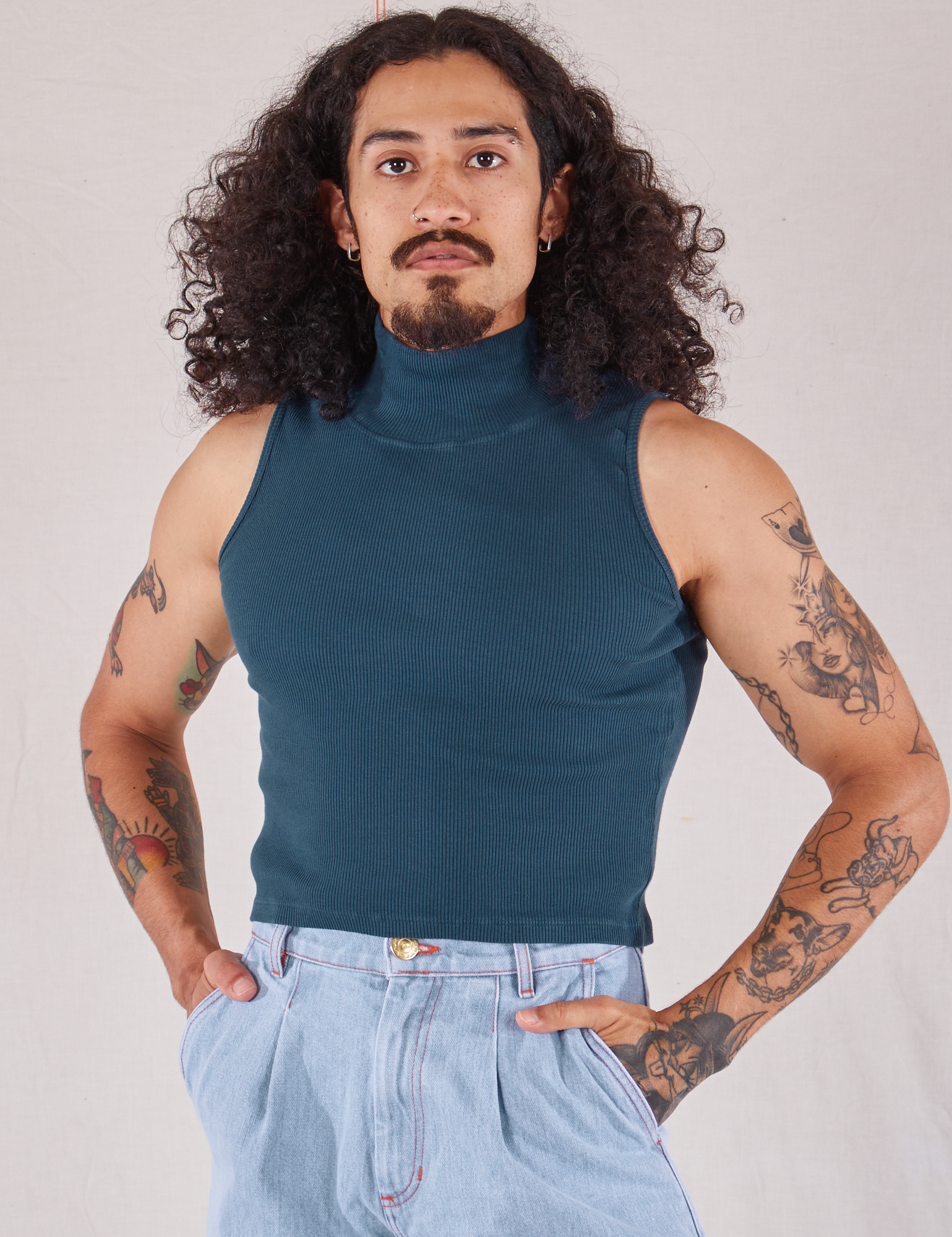 Jesse is wearing Sleeveless Essential Turtleneck in Lagoon