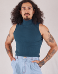 Jesse is wearing Sleeveless Essential Turtleneck in Lagoon