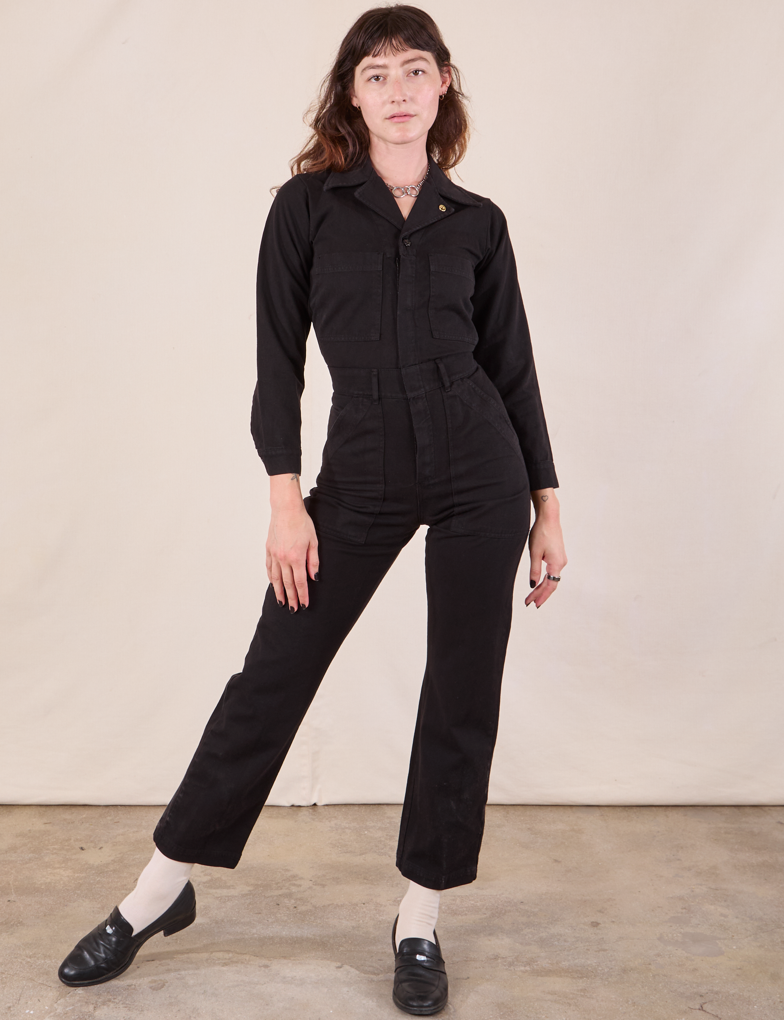 Alex is wearing Long Sleeve Jumpsuit in Basic Black