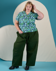 Juliet is 5’7” and wearing L Angel Print Pantry Button-Up paired with evergreen Drop Pocket Cargo Pants