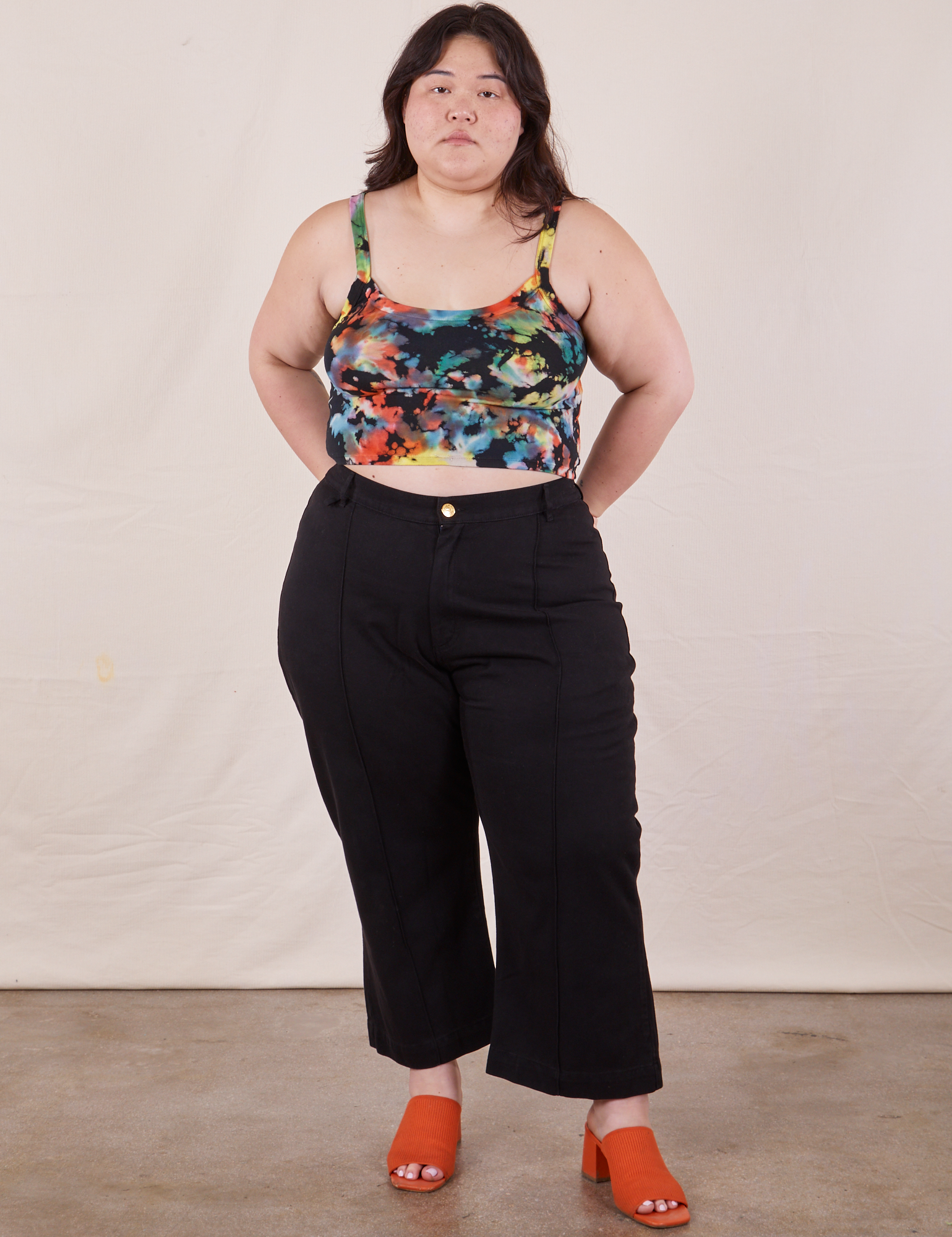 Ashley is wearing Cropped Cami in Rainbow Magic Waters paired with black Petite Western Pants