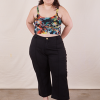 Ashley is wearing Cropped Cami in Rainbow Magic Waters paired with black Petite Western Pants