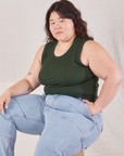 Ashley is wearing Muscle Tee in Swamp Green and light wash Carpenter Jeans