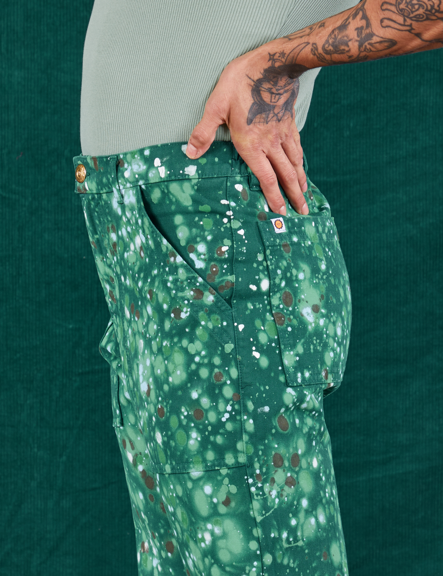 Side view close up of Marble Splatter Work Pants in Hunter Green on Jesse