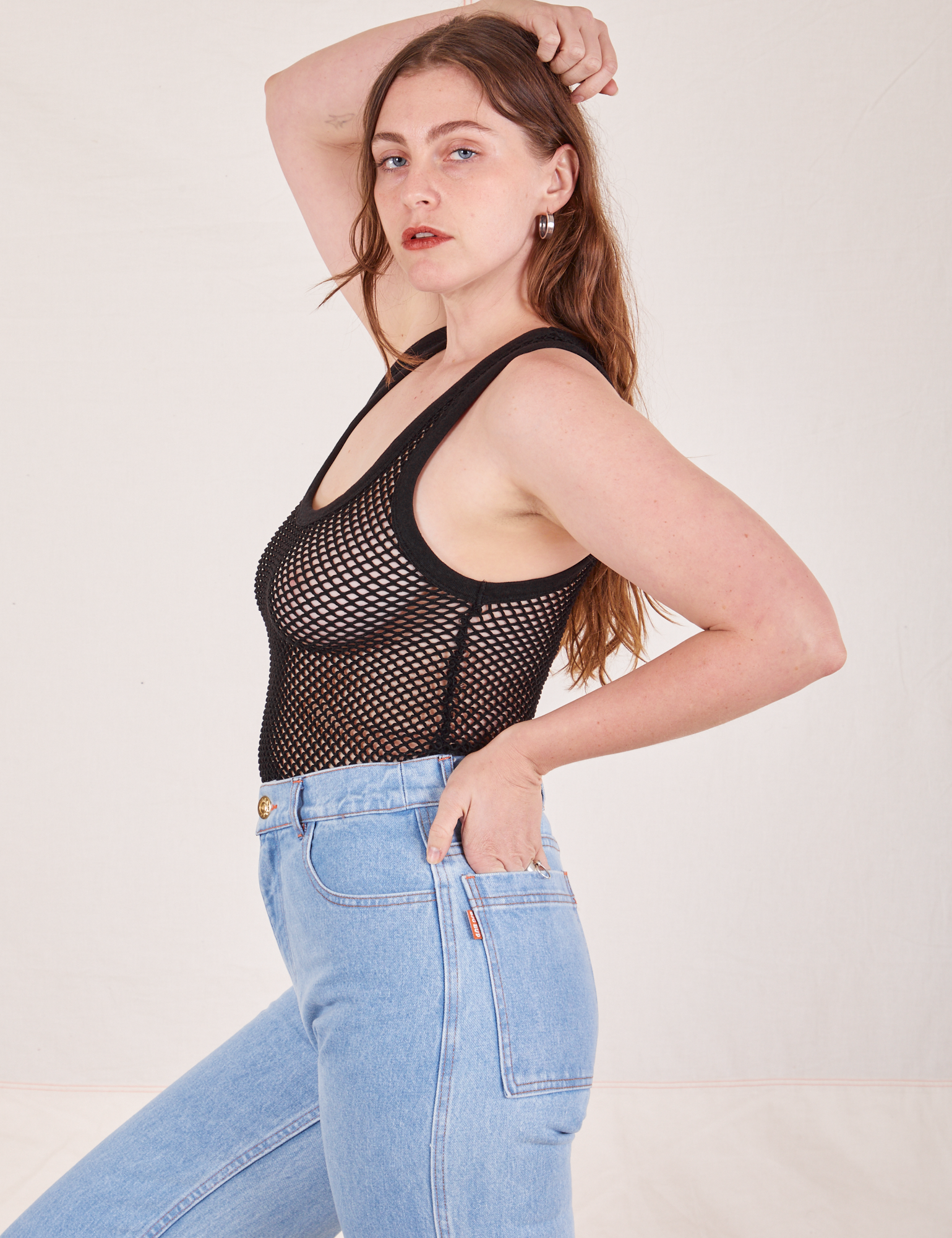 Side view of Mesh Tank Top in Basic Black and light wash Sailor Jeans worn by Allison