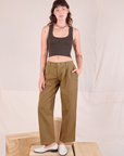 Alex is 5'8" and wearing XXS Mid-Rise Pleated Trousers in Desert Brown paired with espresso brown Cropped Tank