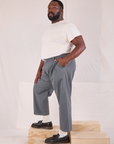 Side view of Mid-Rise Pleated Trousers in Slate Grey and Organic Vintage Tee in vintage tee off-white on Elijah