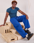 Issac is wearing Mid-Rise Pleated Trousers in Royal Blue and lagoon Baby Tee