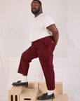 Side view of Mid-Rise Work Pants in Red Wine and Organic Vintage Tee in vintage tee off-white on Elijah