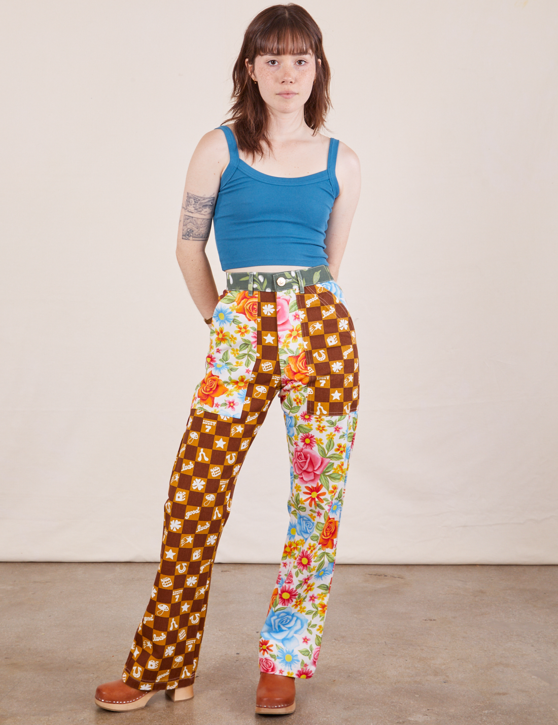 Hana is 5'3" and wearing XXS Petite Mismatched Print Work Pants paired with marine blue Cropped Cami