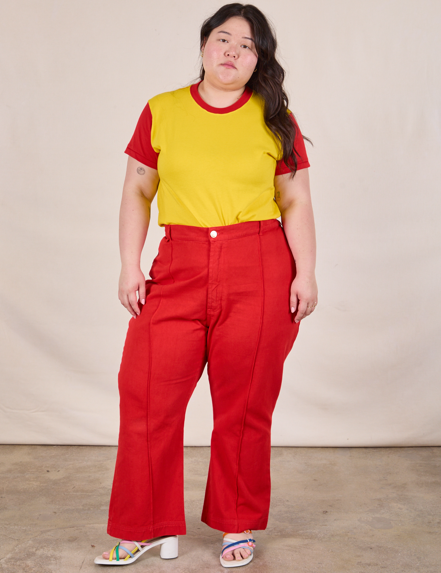 Ashley is wearing Mismatched Tee in Yellow &amp; Red and mustang red Western Pants