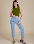 Alex is wearing Muscle Tee in Summer Olive and light wash Carpenter Jeans