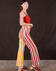 Side view of Western Pants in Ketchup/Mustard Stripes and mustang red Cami on Alex