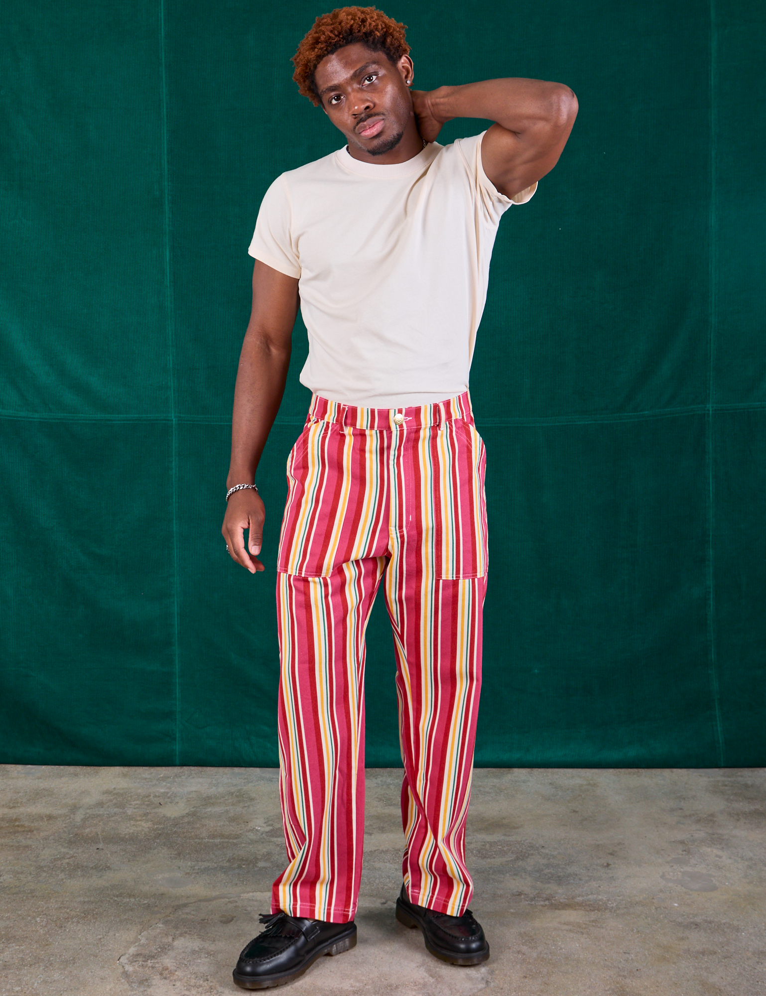 Issac is 5&#39;10&quot; and wearing M Stripe Work Pants in Cherry Candy paired with Organic Vintage Tee in vintage tee off-white