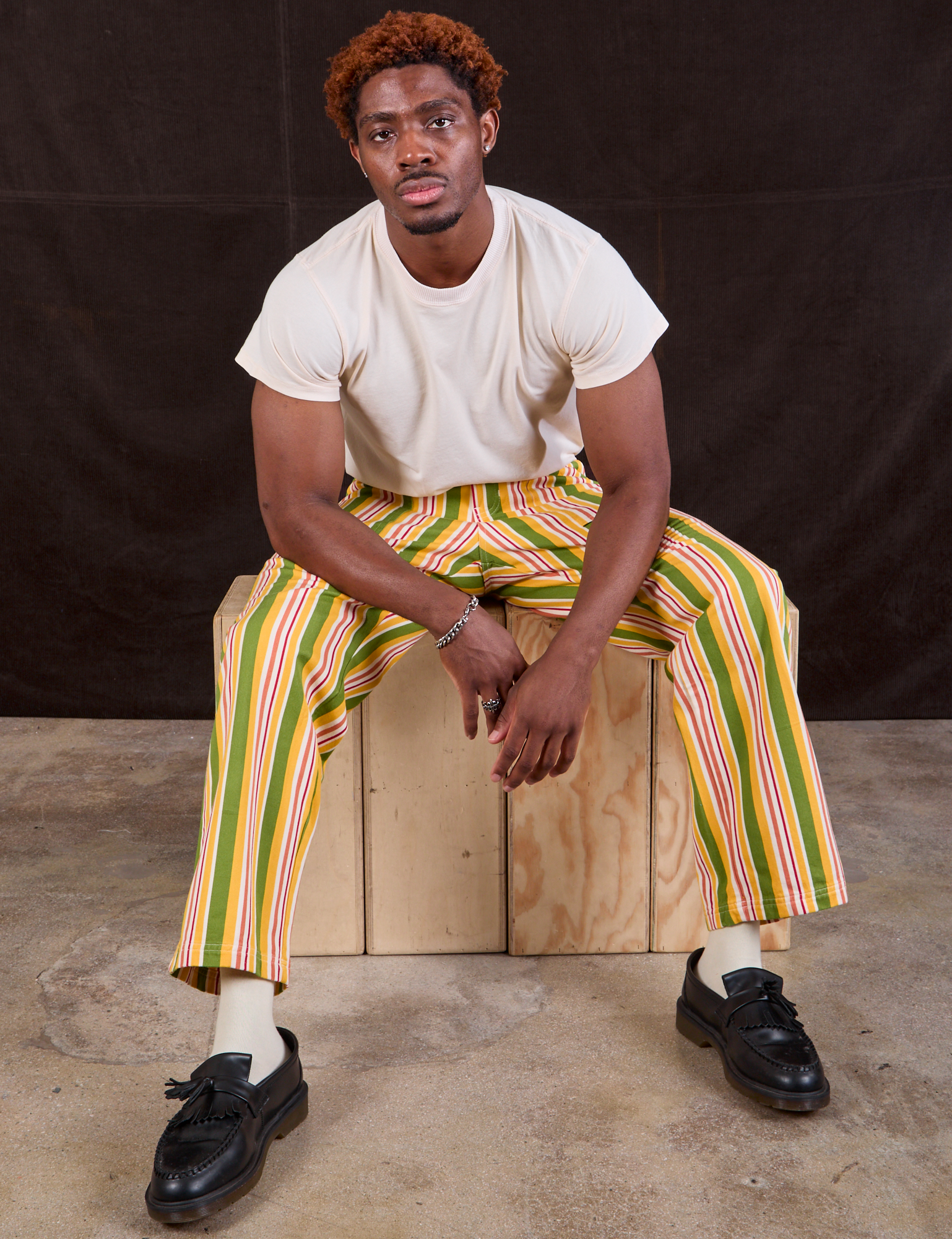 Issac is wearing Stripe Work Pants in Vintage Sofa and Organic Vintage Tee in vintage tee off-white