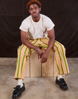 Issac is wearing Stripe Work Pants in Vintage Sofa and Organic Vintage Tee in vintage tee off-white