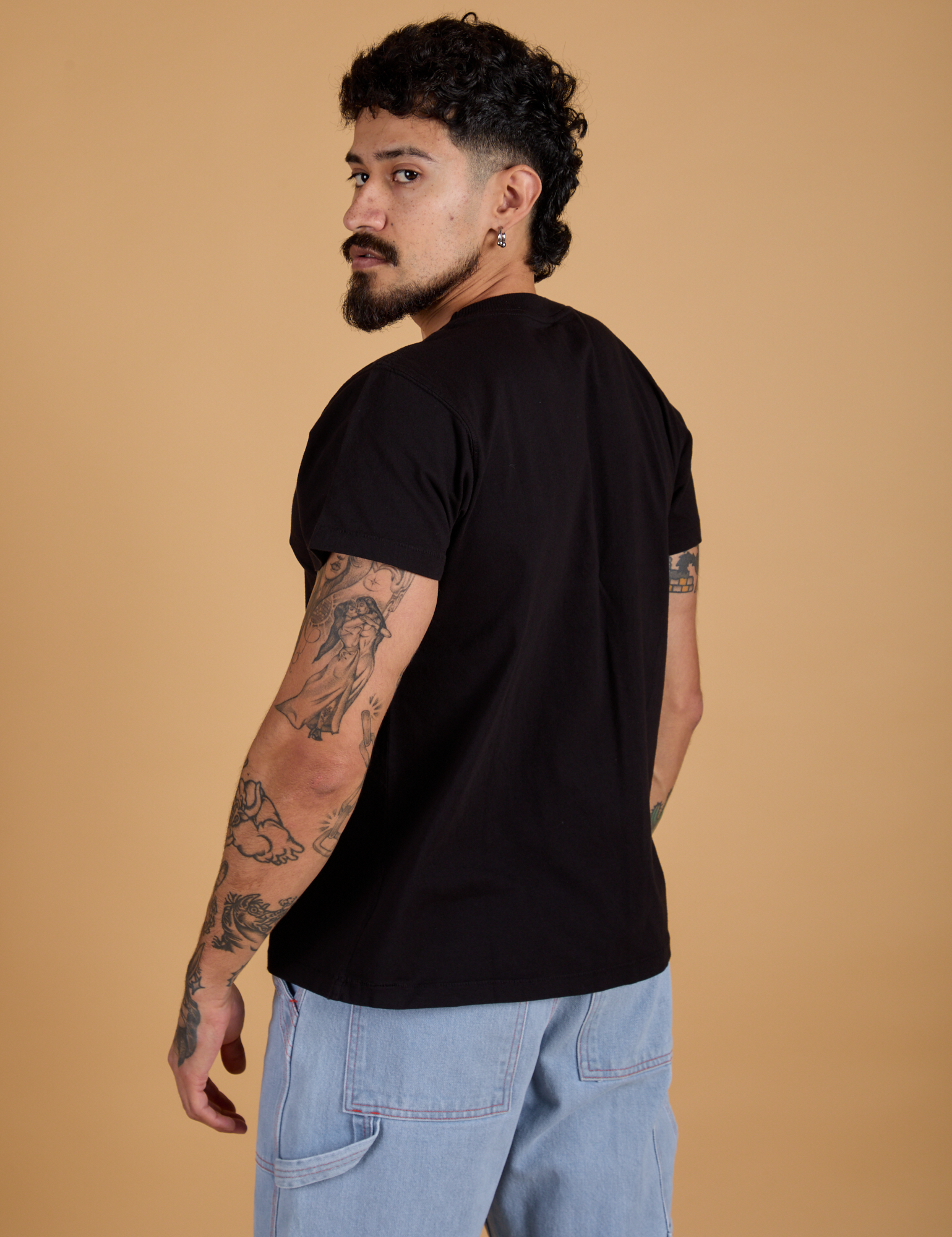 Angled back view of Organic Vintage Tee in Basic Black on Jesse