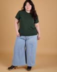 Ashley is wearing Organic Vintage Tee in Swamp Green and light wash Indigo Wide Leg Trousers