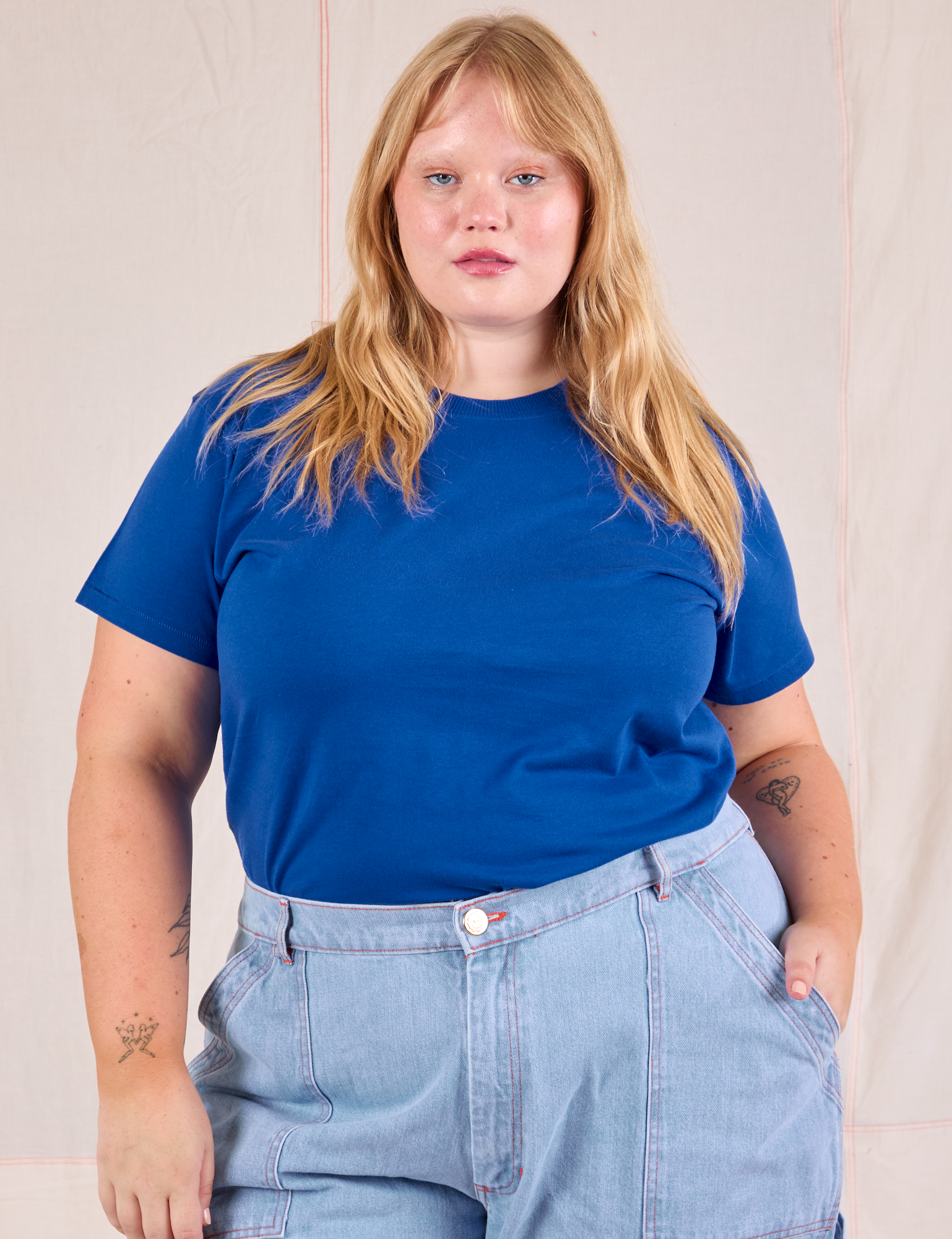 Juliet is wearing Organic Vintage Tee in Royal Blue tucked into light wash Carpenter Jeans