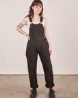 Hana is 5'3" and wearing size P Original Overalls in Mono Espresso with a vintage off-white Cropped Tank Top.