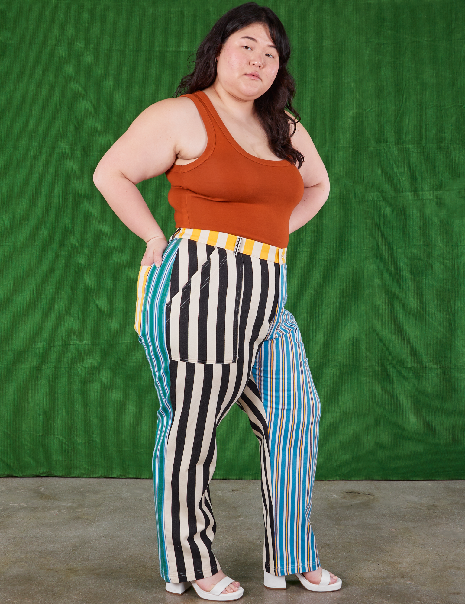 Angled front view of Mismatched Stripe Work Pants and burnt terracotta Cropped Tank Top