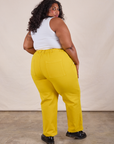 Back view of Work Pants in Golden Yellow and Cropped Tank in Vintage Tee Off-White on Morgan