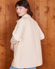 Angled back view of Quilted Overcoat in Vintage Off-White on Alex