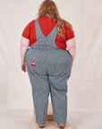 Back view of Railroad Stripe Denim Original Overalls and paprika Baby Tee worn by Catie